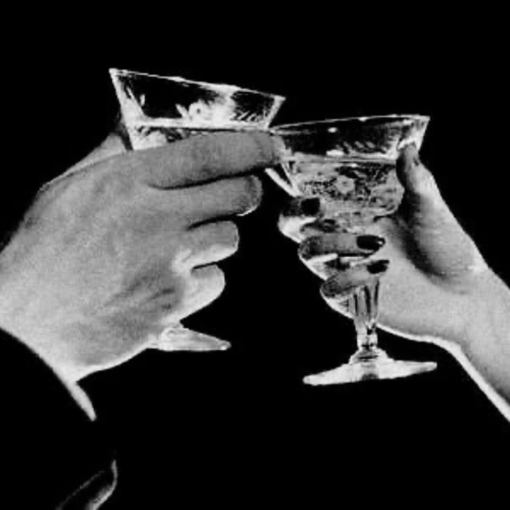 Two hands raising glasses in a toast
